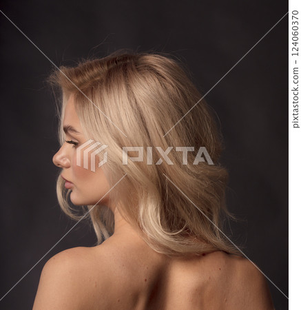 Studio photo portrait of a young pretty blonde on a dark background, close-up portrait of a woman Studio photo portrait of a young pretty blonde on a dark background, close-up portrait of a woman 124060370