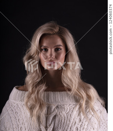 Studio photo portrait of a young pretty blonde on a dark background, close-up portrait of a woman 124060374