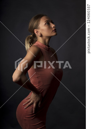 portrait of a young beautiful woman on a dark background 124060387