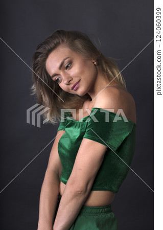 portrait of a young beautiful woman on a dark background portrait of a young beautiful woman on a dark background 124060399
