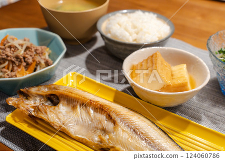 A table lined with grilled fish and Japanese side dishes A table lined with grilled fish and Japanese side dishes 124060786