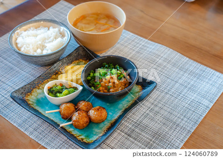A Japanese breakfast of natto and yakitori is served on the table A Japanese breakfast of natto and yakitori is served on the table 124060789