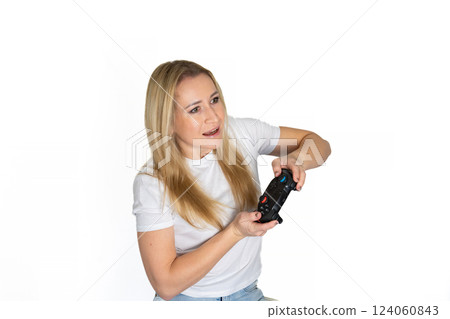 Photo of blond happy excited crazy smiling woman playing videogames addicted to playstation isolated on white background 124060843