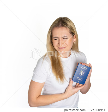 Sad angry blonde ukrainian woman in white t-shirt holding ukrainian passport isolated white background with sad face, negative down rejection concept Sad angry blonde ukrainian woman in white t-shirt holding ukrainian passport isolated white background with sad face, negative down rejection concept 124060941