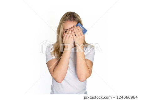 Sad angry blonde ukrainian woman in white t-shirt holding ukrainian passport isolated white background with sad face, negative down rejection concept Sad angry blonde ukrainian woman in white t-shirt holding ukrainian passport isolated white background with sad face, negative down rejection concept 124060964