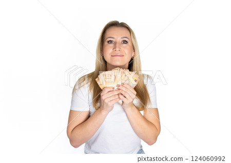 Woman in white t-shirt with dollars in hand. Portrait blonde woman holding money bills. Blond girl holding cash money in euro. Woman holding lots of money in euro currency. Luxury, and money concept. 124060992