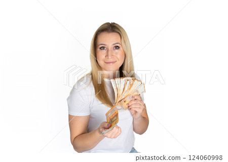 Woman in white t-shirt with dollars in hand. Portrait blonde woman holding money bills. Blond girl holding cash money in euro. Woman holding lots of money in euro currency. Luxury, and money concept. 124060998