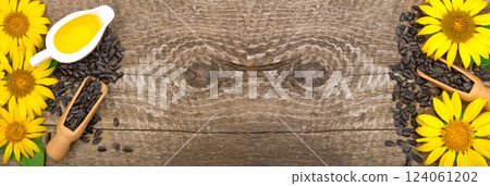 Sunflower oil, seeds and flower on wooden background with copy space for your text. Top view 124061202