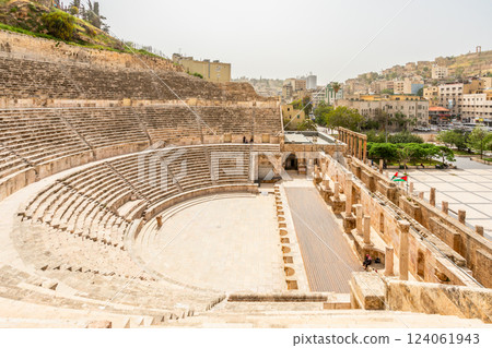 Ancient roman amphitheater arena with central square and many residential houses on the hills in Al Balad downtown of Amman city, Kingdom of Jordan Ancient roman amphitheater arena with central square and many residential houses on the hills in Al Balad downtown of Amman city, Kingdom of Jordan 124061943