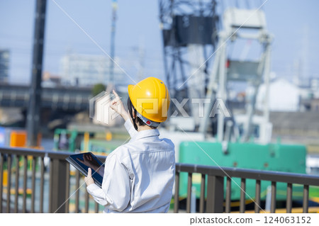 Woman in work clothes at a construction site Woman in work clothes at a construction site 124063152