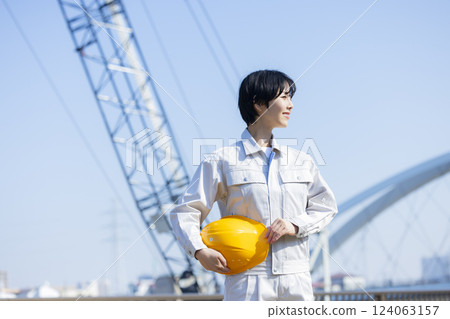Woman in work clothes at a construction site 124063157