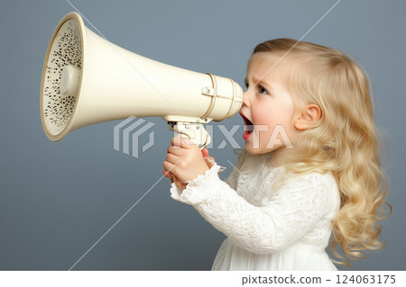 Young Girl Holding Megaphone and Speaking Loudly in a Studio Setting with Neutral Background Young Girl Holding Megaphone and Speaking Loudly in a Studio Setting with Neutral Background 124063175