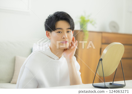 A young man looking at a mirror 124063271