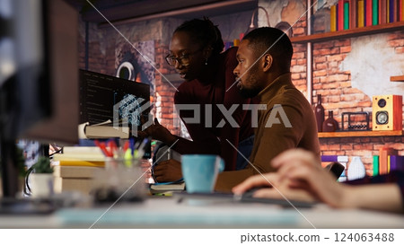 Startup staff members gathered together to conduct code review to fix bugs, identifying technical issues. Artificial intelligence company coworkers doing brainstorming, optimizing code, camera B 124063488