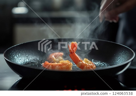 Chef frying shrimps in pan with hot steam in restaurant kitchen Chef frying shrimps in pan with hot steam in restaurant kitchen 124063538