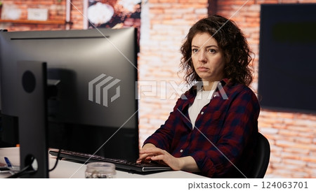 AI startup company developer testing company software to minimize occurrence of bugs, identifying bottlenecks. Woman in office writing code in programming language to reduce errors AI startup company developer testing company software to minimize occurrence of bugs, identifying bottlenecks. Woman in office writing code in programming language to reduce errors 124063701