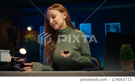 Focus on mobile phone used by influencer to film content for her online fans, talking about gen Z topics. Content creator records vlog for internet channel with cellphone on tripod, camera B close up Focus on mobile phone used by influencer to film content for her online fans, talking about gen Z topics. Content creator records vlog for internet channel with cellphone on tripod, camera B close up 124063715