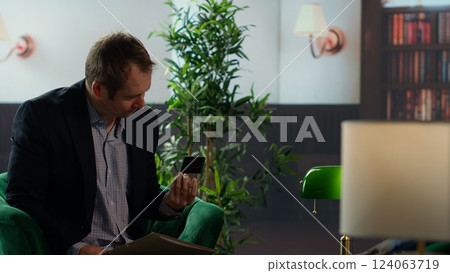 Government agents discuss confidential data stored on a SSD, intelligence services protect state secrets. Spies review crucial information on a system unit, drinking whiskey together. Camera B. 124063719