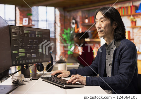 Senior technician coding advanced AI algorithm in startup office, refining machine learning models to enhance automation. Asian CTO manager using coding platform in Silicon Valley workplace 124064103