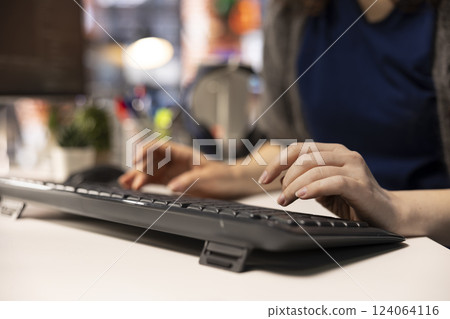 Technician at the office looking at UI on computer monitor and executing programming code. IT freelance worker using coding application to write and test code in modern apartment. Close up. 124064116