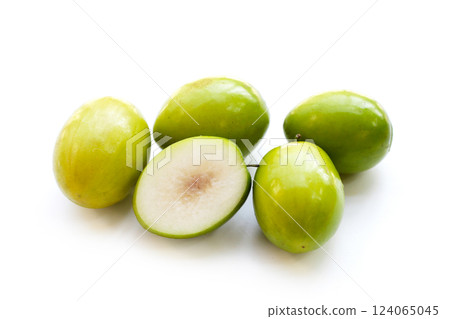 Green jujube fruits on white background. Green jujube fruits on white background. 124065045