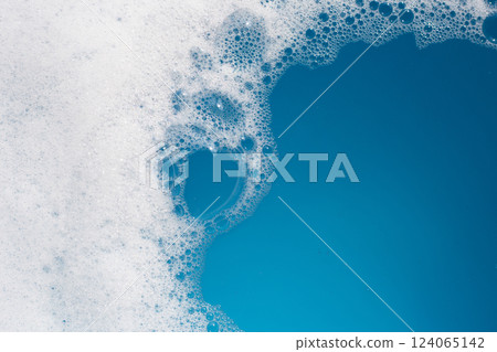 Detergent foam bubble on water. Blue background, Soap sud Detergent foam bubble on water. Blue background, Soap sud 124065142