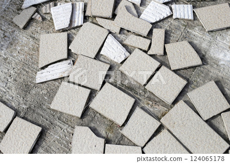 Cracked brown tiles on cement floor 124065178
