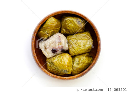 Bundled boiled sticky rice with banana and black beans wrapped in banana leaves Bundled boiled sticky rice with banana and black beans wrapped in banana leaves 124065201