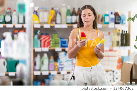 Young woman choosing insect repellents in household store Young woman choosing insect repellents in household store 124067362
