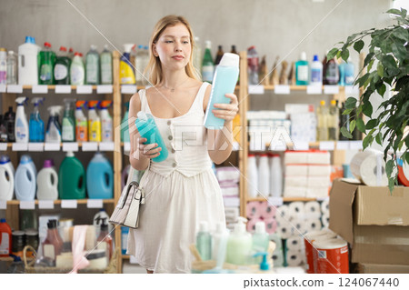 Young female customer choosing shower gel in personal care store Young female customer choosing shower gel in personal care store 124067440