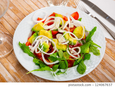 Healthy vegan salad with avocado, arugula and tomato Healthy vegan salad with avocado, arugula and tomato 124067637