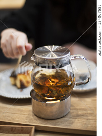 Glass Teapot with Loose Leaf Tea on Warmer Glass Teapot with Loose Leaf Tea on Warmer 124067683