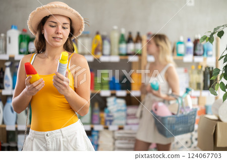 Young girl choosing repellent while other choosing something in background 124067703