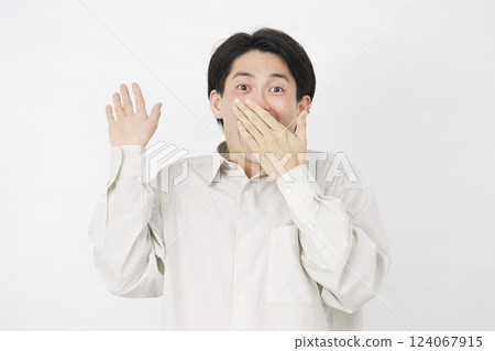 Man in his 20s, surprised with a smile, white background 124067915