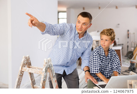 Father and son talking about home improvement works in apartment Father and son talking about home improvement works in apartment 124067975