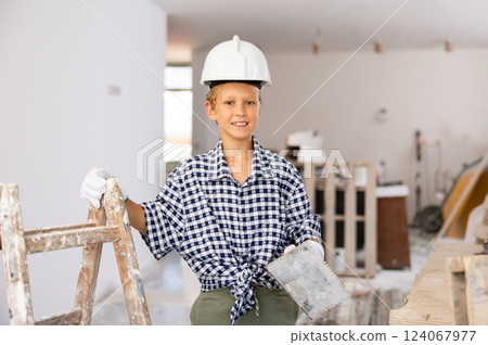 Portrait of young cheerful boy in construction site 124067977