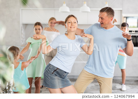 Happy large family listens to music, dances at home and celebrates beginning of summer vacation 124067994