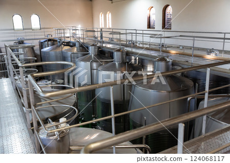 Interior of winery with stainless steel tanks 124068117