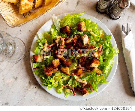 Lettuce, crouton, lardon salad on plate Lettuce, crouton, lardon salad on plate 124068194