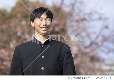 A high school boy standing in front of the cherry blossoms 124068783