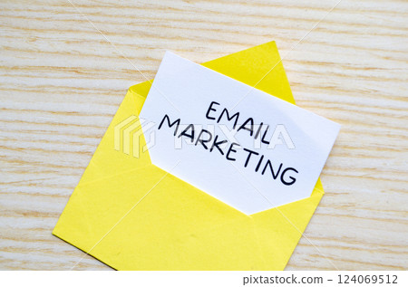 Email marketing text on white notepad inside a yellow envelope. Making money online concept. Email marketing text on white notepad inside a yellow envelope. Making money online concept. 124069512