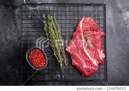 Raw hanging tender or onglet beef steak. black background. top view Raw hanging tender or onglet beef steak. black background. top view 124070031