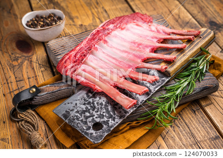 Butcher board with Raw lamb meat for chops steaks, fresh rack of mutton. wooden background. top view Butcher board with Raw lamb meat for chops steaks, fresh rack of mutton. wooden background. top view 124070033
