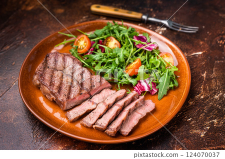Grilled Australian Oyster Top blade steak with salad on a plate. brown background. top view Grilled Australian Oyster Top blade steak with salad on a plate. brown background. top view 124070037