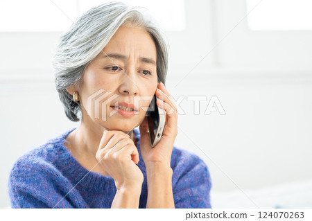 Senior woman talking on smartphone 124070263