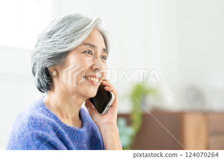 Senior woman talking on smartphone 124070264