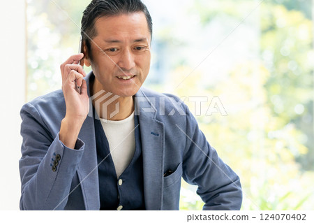Middle-aged man talking on smartphone Middle-aged man talking on smartphone 124070402