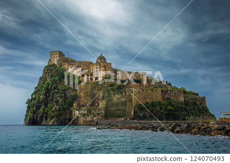 Ischia, Italy with Aragonese Castle in the Mediterranean at dusk 124070493