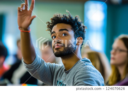 Student raises hand during classroom discussion Student raises hand during classroom discussion 124070626