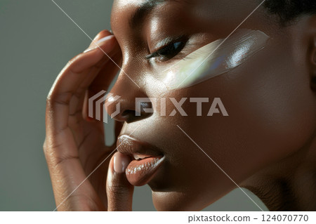Woman applying skincare cream on face Woman applying skincare cream on face 124070770